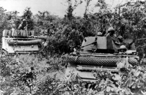 M113 Armored Personnel Carriers with cyclone fence RPG screens on front, Vietnam