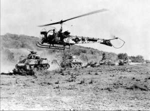 M4 Sherman medium tanks is observed by a Bell OH-13 Sioux helicopter, circa early 1950s.jpg