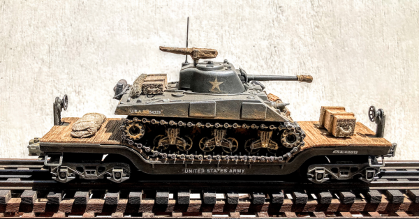 U.S. Army M4A3(75) Sherman Tank on 35′ Drop Center Flat Car USA 23073(AV13.1-FC5.2USA)_Operates on 3-Rail “O”Gauge track • Available Today • (CTN 30)