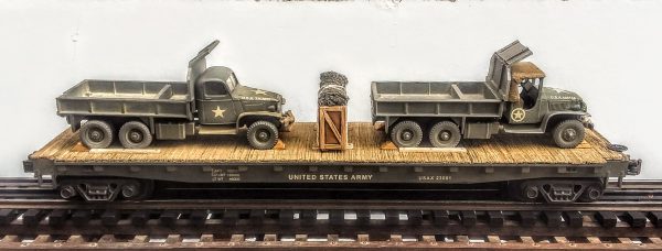 US Army GMC 6X6 Cargo-Dump Trucks x 2 w/Cab Protectors on 50′ Flat Car USAX23001(MV1LM-LM-FC6.2USA)_Operates on 3-Rail “O”Gauge track • Available Today • (CTN 41)