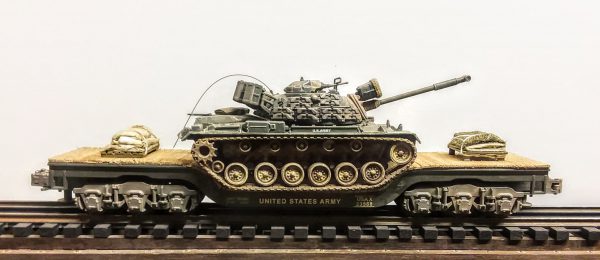 US Army M48A3 Patton Tank, Vietnam, on 45′ Drop Center Flat Car USAX 23568(AV19-FC8.2USA)_Operates on 3-Rail “O”Gauge track • Available Today • (CTN 23)