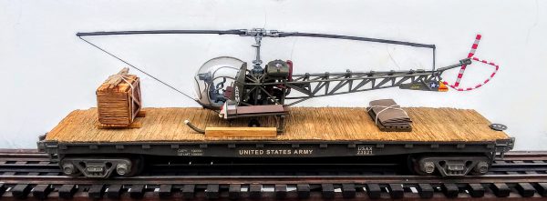 US Army H-13 Sioux Evacuation Helicopter on 47′ Flat Car, Korean War(MASH)-Vietnam USAX 23549(HELI13S.1-FC11.2USA)_Operates on 3-Rail “O”Gauge track • Available Today • (CTN 27)