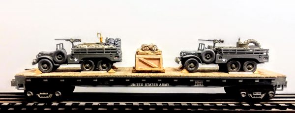 US Army_WC63 Dodge x2 6×6 Open Top Cargo Carrier with Supply Loads  & 50 Cal M.G.’s on Pedestals on 50′ Flat Car USAX 23563(MV9AA-FC6.2USA)_Operates on 3-Rail “O”Gauge track  • Available Today • (CTN 24)