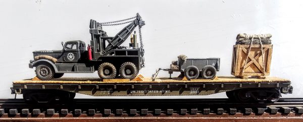 US Army Diamond T 969 4-Ton Wrecker  w/1-Ton 4-Whl Trailer & Wood Crate Supply Load on 50′ flat Car USAX23039(V15.5-FC6.2USA)_Operates on 3-Rail “O”Gauge track  • Available Today • (CTN 29)