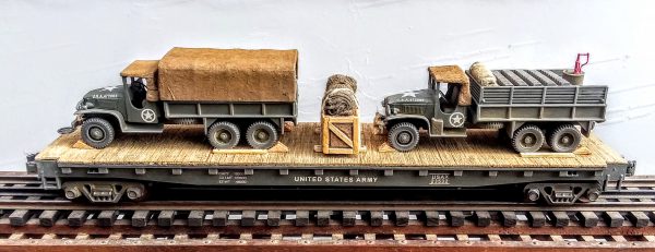 US Army GMC 6X6 Cargo Truck w/Cover & Cargo Truck w/Gas Cans on 50′ Flat Car USAX 23532(MV1AD-FC6.2USA)_Operates on 3-Rail “O”Gauge track  • Available Today • (CTN 41)