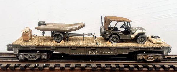 US Army Willy’s Jeep with Cover & Zodiac Assault Boat with Outboard Motor on Tow Trailer on 40′ Flat Car_U.S.A.3303852(V4B.1-FC2.2USA)_Operates on 3-Rail “O”Gauge track  • Available Today • (CTN 20)