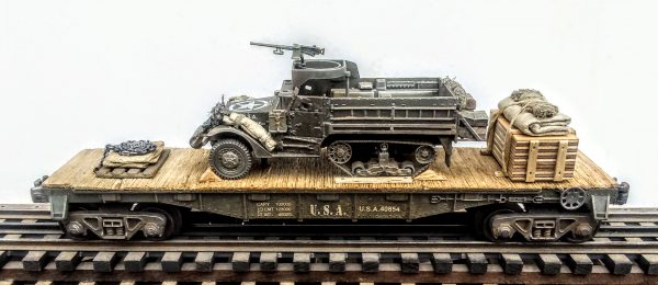 US Army M3A1 Half Track w/50 Cal Gun Ring & Supply Load on 40′ Flat Car U.S.A. 40854(AV9F.4-FC2.2USA)_Operates on 3-Rail “O”Gauge track  • Available Today • (CTN 1)