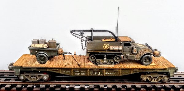 US Army M3 Half Track w/Recovery Hoist & Trailer Tow w/Supply Load on 40′ Flat Car USA 23277(AV9D-FC2.2USA)_Operates on 3-Rail “O”Gauge track  • Available Today • (CTN 1)